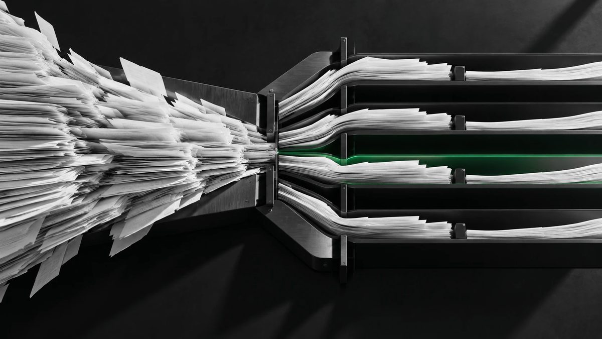 A loose stream of paper documents funnelled through a steel machine and sorted into separate lanes, one of them lit green.